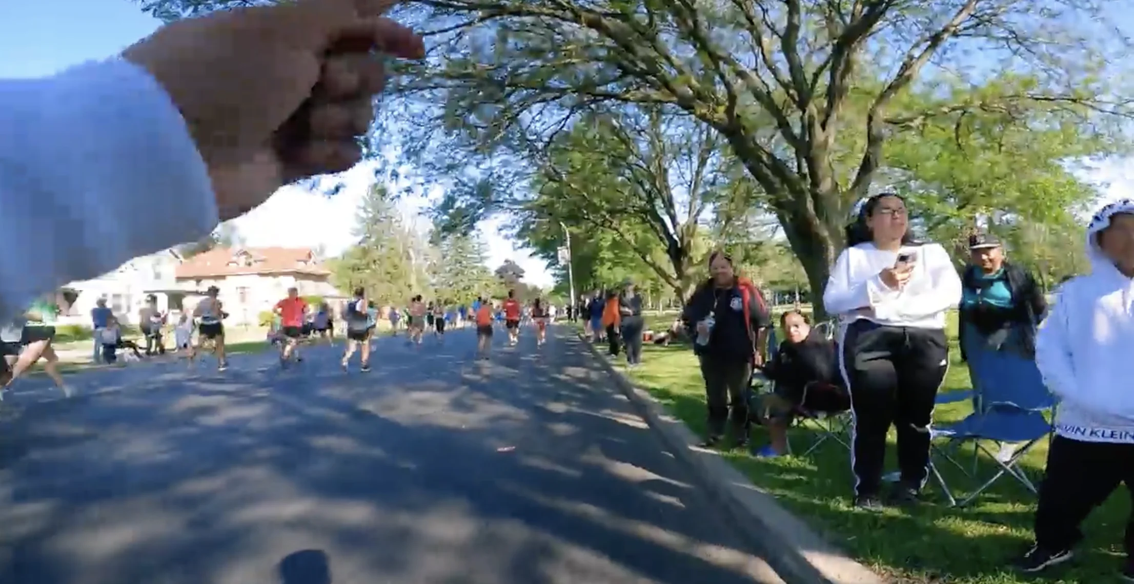 Runners and spectators along the race route during the Big Feet activation