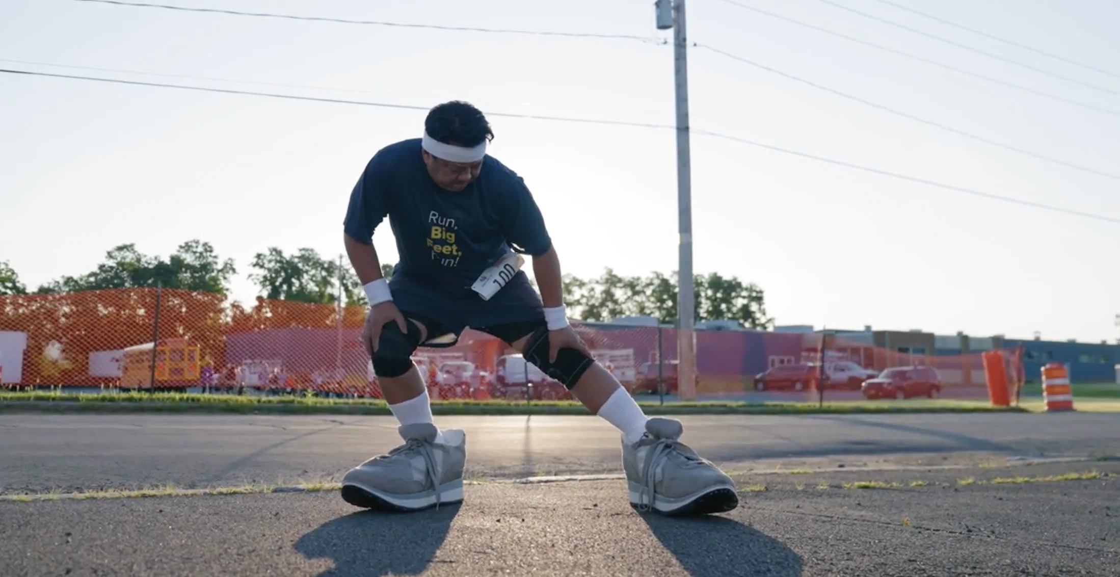 A runner wearing oversized shoes — Big Feet for New York State