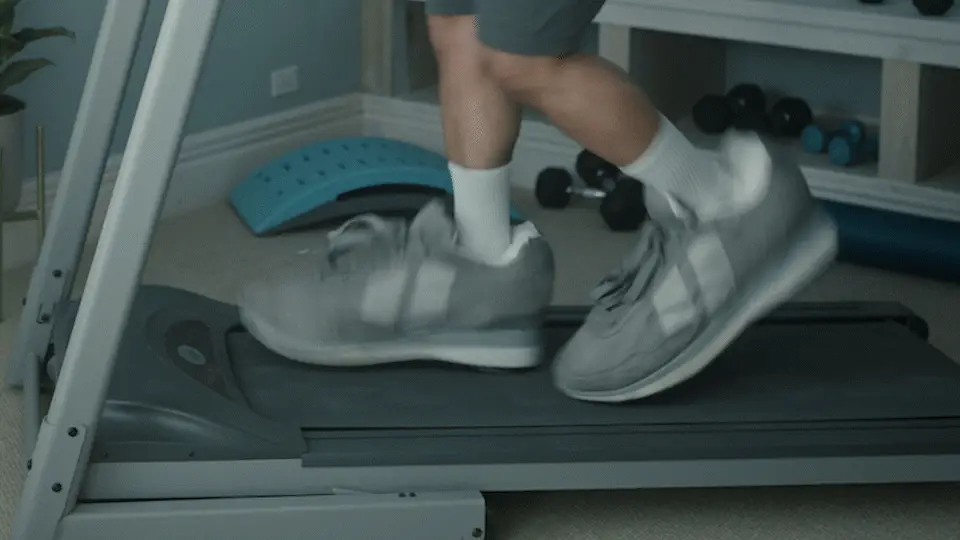 Oversized shoes running on a treadmill in the Big Feet campaign