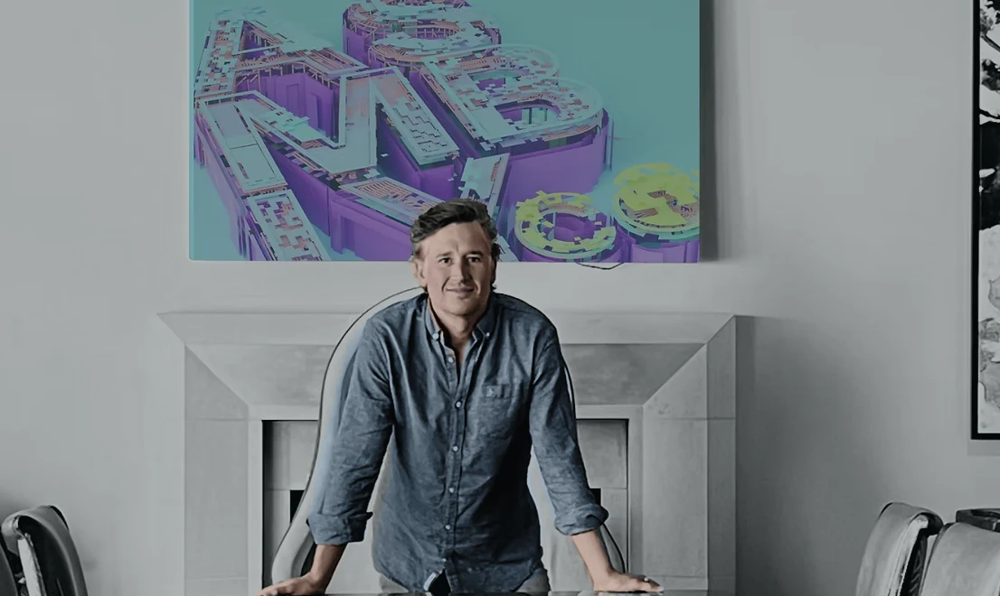 Kevin Willard beneath colorful ASMBLY artwork