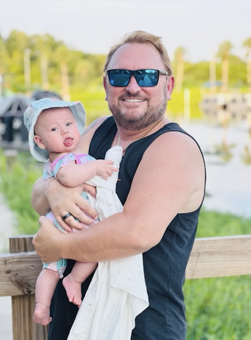 Tim holding his daughter