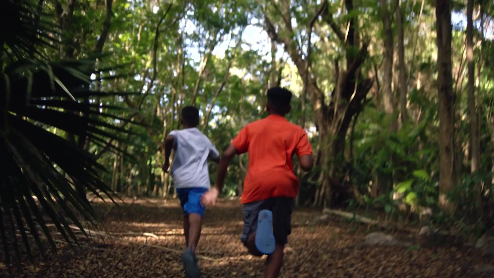 Two children running through an island forest trail — U.S. Virgin Islands, Real Nice campaign